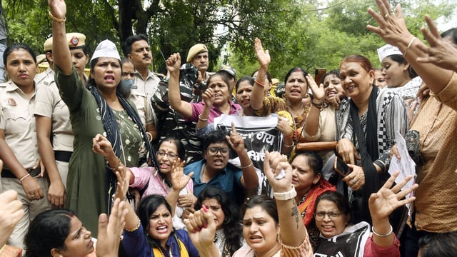 Women raise slogans as they stage a protest over the killing of Ankita Bhandari and demanding justice for her in Delhi.