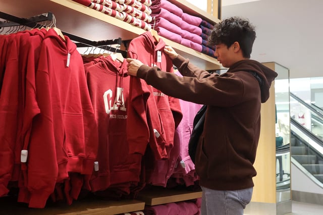 A person shops on Thanksgiving at a Gap store in Times Square, ahead of Black Friday, in New York City, U.S., November 28, 2024. REUTERS/Brendan McDermid/File Photo