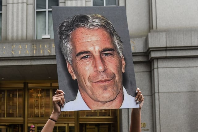 A protester hold up a photo of Jeffrey Epstein in front of the federal courthouse on July 8, 2019 in New York City.