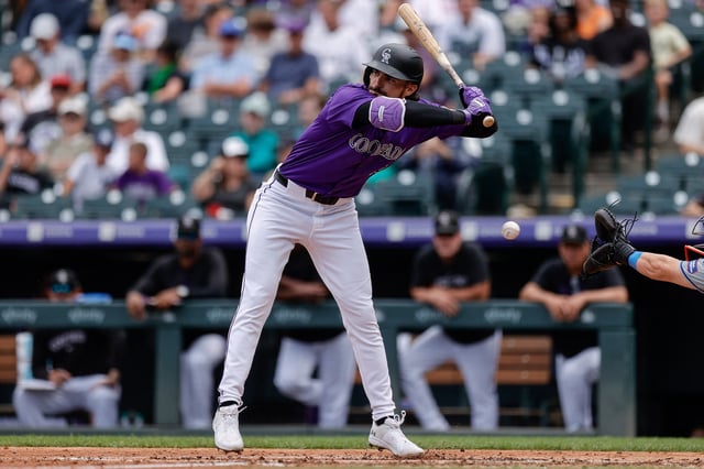 Aug 8, 2024; Denver, Colorado, USA; Colorado Rockies left fielder Sam Hilliard (16) moves away from a pitch in the fifth inning against the New York Mets at Coors Field. Mandatory Credit: Isaiah J. Downing-USA TODAY Sports