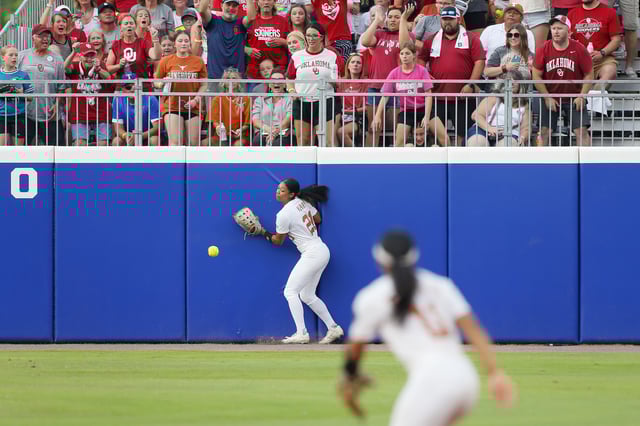 Center fielder Kayden Henry #21 of the Texas Longhorns is unable to reach a double hit by Alyssa Brito #33 of the Oklahoma Sooners in the second inning of the second game of the Championship Finals during the 2024 NCAA Women&#39;s College World Series at OGE Energy Field at Devon Park on June 6, 2024 in Oklahoma City, Oklahoma. Oklahoma won 8-4 to take the NCAA Championship.