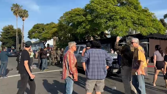 People and law enforcement officers outside Italian restaurant Buona Forchetta in San Diego’s South Park neighborhood on May 30, 2025.