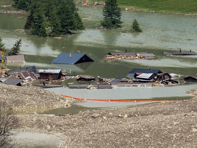  This photograph shows debris and the rest of the village of Blatten now submerged by the obstructed river Lonza, after the huge Birch Glacier collapsed and a massive landslide that threw tons of rock, ice and scree down the mountainside and into the valley below, in Wiler, in the Swiss Alps, on May 31, 2025.  (Photo by Fabrice COFFRINI / AFP)