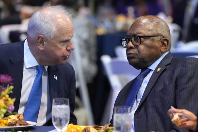 Walz speaks with Rep. Jim Clyburn at the South Carolina Democratic Party's Blue Palmetto Dinner on May 30, 2025, in Columbia, South Carolina.