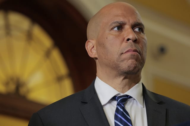 U.S. Sen. Cory Booker (D-NJ) listens as U.S. Senate Minority Leader Chuck Schumer (D-NY) speaks to reporters following the weekly Senate Democrat policy luncheon at the U.S. Capitol on April 29, 2025 in Washington, DC.