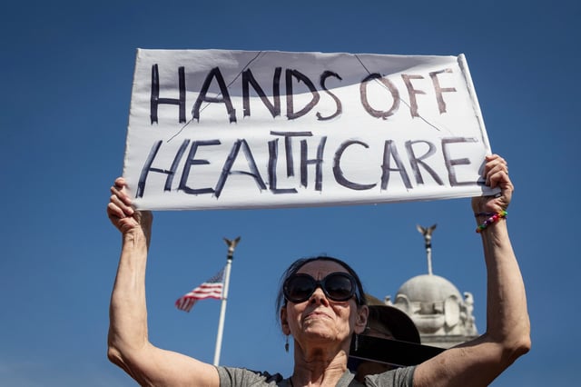 Brenda Patoine of Vermont joins over a thousand people at a march against efforts to dismantle and defund the healthcare system in Washington, on March 12, 2025. 
