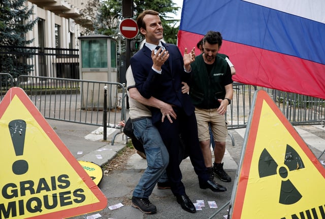 Greenpeace activists install a wax statue of French President Emmanuel Macron borrowed from the Grevin Museum without permission, to denounce what they call France's continued commercials ties with Russia despite the war in Ukraine, in front of the Russian Embassy in Paris, France, June 2, 2025. REUTERS/Benoit Tessier