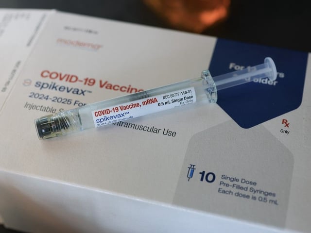 A Moderna COVID-19 vaccine fills a syringe. 
