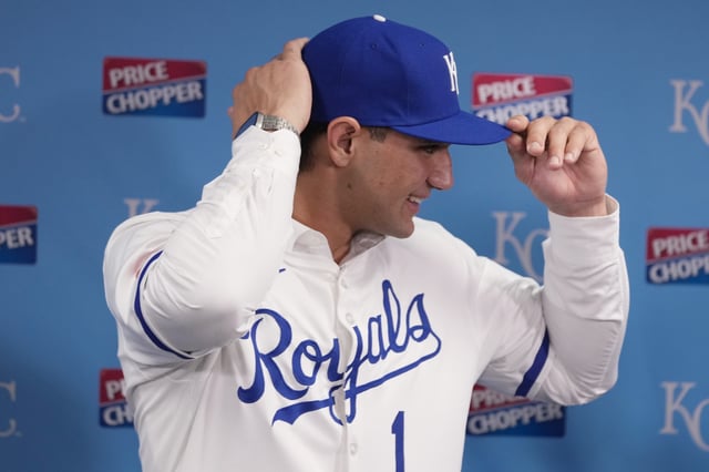 KANSAS CITY, MISSOURI - JULY 24: Jac Caglianone, the Kansas City Royals&#39; first-round draft pick, puts on his cap as he is introduced during a press conference prior to a game between the Arizona Diamondbacks Kansas City Royals at Kauffman Stadium on July 24, 2024 in Kansas City, Missouri.