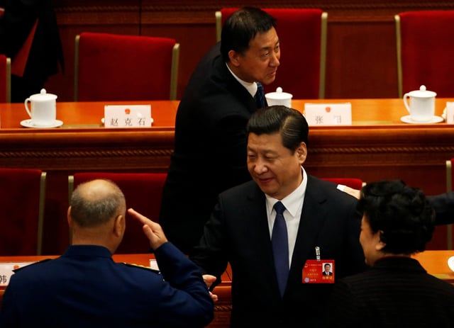Xu Qiliang (L), vice Chairman of China's Central Military Commission, salutes China's President Xi Jinping (C) during the closing ceremony of the Chinese National People's Congress (NPC) at the Great Hall of the People, in Beijing, March 13, 2014. REUTERS/Kim Kyung-Hoon (CHINA - Tags: POLITICS MILITARY)/File Photo