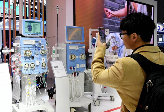 A visitor takes a photo at the 2025 China Medical Equipment Conference &amp; Medical Equipment Exhibition at the Chongqing International Expo Center on March 14, 2025 in Chongqing, China.