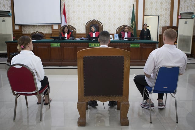 British nationals, from left, Lisa Stocker, Jonathan Collyer, and Phineas Float who are accused of smuggling nearly a kilogram (over two pounds) of cocaine into Indonesia sit on the defendant's chairs during their trial hearing at Denpasar District Court in Denpasar, Bali, on Tuesday, June 3, 2025. (AP Photo/Firdia Lisnawati)