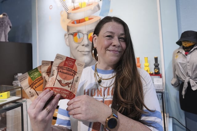 Employee Savannah Gavlik displays THC products at the Dope Daughters dispensary that Texas lawmakers are seeking to ban, Thursday, May 29, 2025, in Austin, Texas. (AP Photo/Eric Gay)
