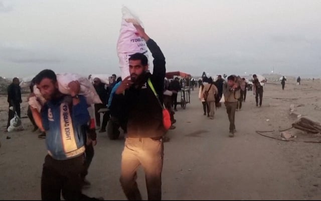 Palestinians carry aid supplies which they received from the U.S.-backed Gaza Humanitarian Foundation, in Rafah, in the southern Gaza Strip, June 3, 2025, in this screengrab taken from video. Reuters TV via REUTERS