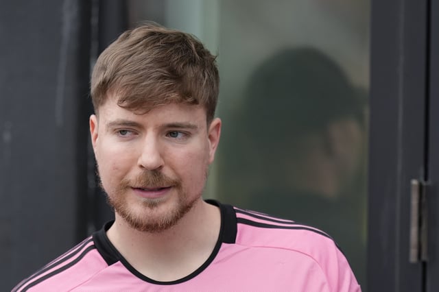 Jimmy Donaldson, the popular YouTube video maker who goes by MrBeast, wears a Lionel Messi jersey as he stands in a sideline box at the start of an MLS soccer match between Inter Miami and CF Montreal Sunday, March 10, 2024, in Fort Lauderdale, Fla.