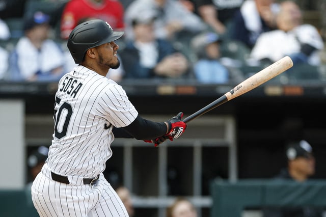 May 24, 2025; Chicago, Illinois, USA; Chicago White Sox second baseman Lenyn Sosa (50) hits a three-run double against the Texas Rangers during the sixth inning at Rate Field. Mandatory Credit: Kamil Krzaczynski-Imagn Images