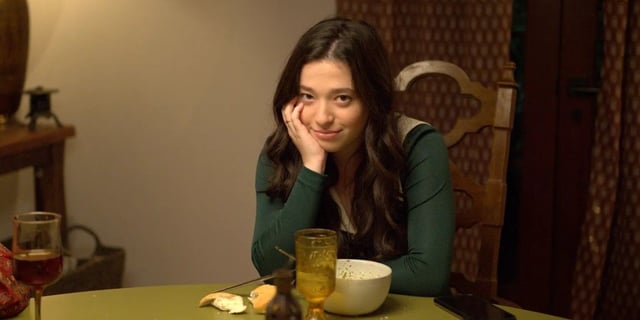 Mikey Madison in Better Things sits at the kitchen table smiling