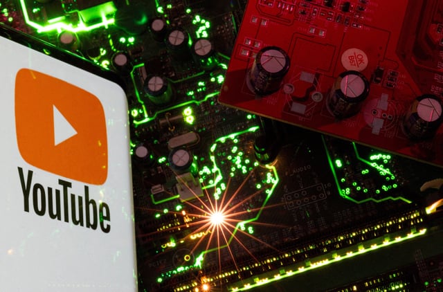 A smartphone with a displayed YouTube logo is placed on a computer motherboard in this illustration taken February 23, 2023. REUTERS/Dado Ruvic/Illustration/File Photo