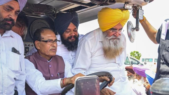 Union agriculture minister Shivraj Singh Chouhan drives a tractor as Punjab agriculture minister Gurmeet Singh Khudian (right) accompanies him to a Kisan Chaupal at Kheri Gandiyan village in Rajpura, Patiala, on Thursday. (PTI Photo)