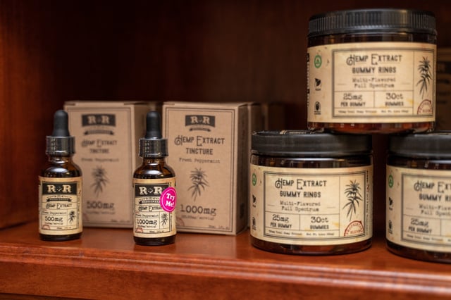 Various wellness products containing full spectrum Cannabidiol (CBD) from R+R Medicinals, including oil tinctures, topical cream, edible gummies, and pet products visible on the shelves of a boutique retail store in Denver, Colorado, August 9, 2020.
