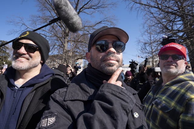 FILE - Former Proud Boys leader Enrique Tarrio is flanked by Dominic Pezzola, left, and Joseph Biggs, right, at a news conference outside the U.S. Capitol in Washington, Feb. 21, 2025. (AP Photo/J. Scott Applewhite, File)