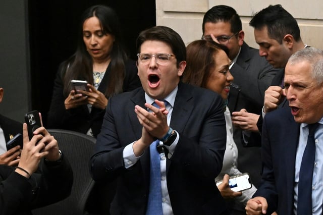 Senator Miguel Uribe (C) reacts after the Senate voted against the government labor reform referendum promoted by Colombia's President Gustavo Petro on May 14, 2025