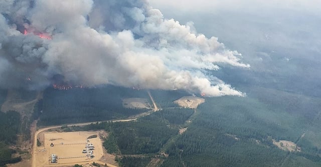 Smoke rises from areas on the southeast side of wildfire EWF-035, part of the Deep Creek Wildfire Complex which is being tackled by helicopters near Shining Bank, Alberta, Canada May 19, 2023. Alberta Wildfire/Handout via REUTERS   