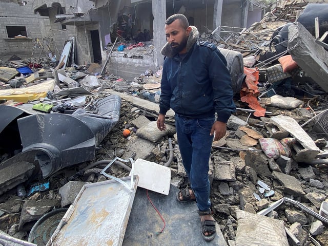 Palestinian Ibrahim Al-Haj Youssef, who lost four of his children and his wife in an Israeli air strike, stands amid debris, amid the ongoing conflict between Israel and Hamas, at the Maghazi camp, in the central Gaza Strip. Photo: Reuters