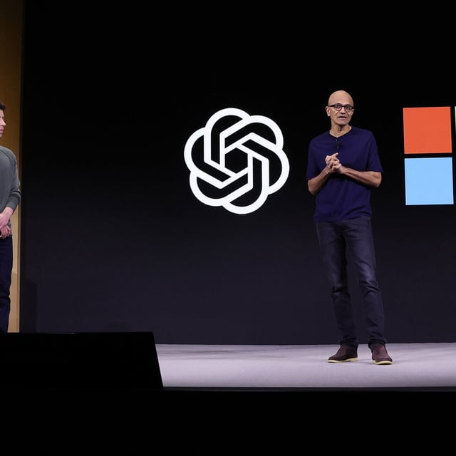 Microsoft CEO Satya Nadella speaks as OpenAI's Sam Altman looks on during the OpenAI DevDay event on November 06, 2023, in San Francisco.
