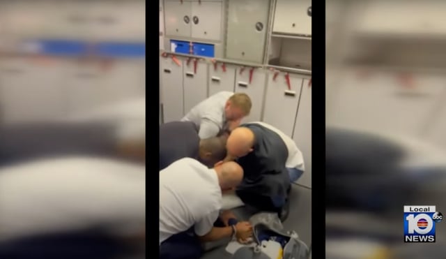 Passengers and airline crew restrain the man