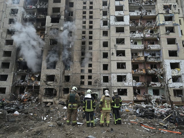 TOPSHOT - Firefighters work in a multi-storey residential building destroyed by a missile attack in central Kyiv, on January 2, 2024, amid the Russian invasion of Ukraine. Russian strikes on Ukraine's capital, Kyiv, and the northeastern city of Kharkiv killed at least five people. Russian President Vladimir Putin on January 1, 2024 vowed to intensify strikes on Ukraine. The military campaign has dragged on for nearly two years. (Photo by Genya SAVILOV / AFP) (Photo by GENYA SAVILOV/AFP via Getty Images)