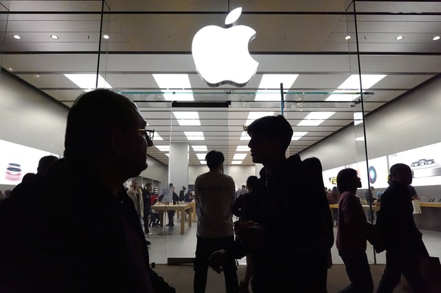 People walk past the Apple store in the Americana at Brand shopping center on the day after Christmas on December 26, 2023 in Glendale, California.