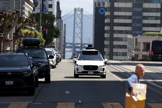 A Waymo autonomous vehicle drives along California Street on April 11, 2022, in San Francisco. With its competitor Cruise floundering, Waymo’s cars are the main driverless presence on the city’s roads as of January 2024.