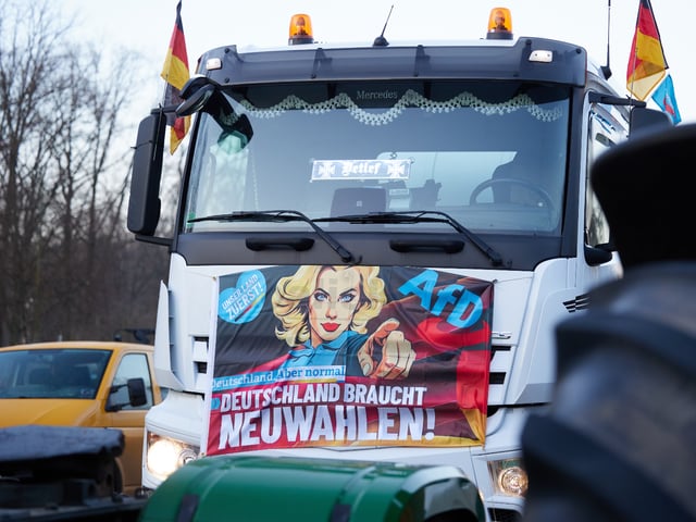 08 January 2024, Berlin: An AfD banner can be seen on a truck on the sidelines of a farmers' protest on the Straße des 17. In response to the federal government's austerity plans, the farmers' association has called for a week of action with rallies and rallies starting on January 8. It is to culminate in a major demonstration in the capital on January 15. Photo: Jörg Carstensen/dpa (Photo by Jörg Carstensen/picture alliance via Getty Images)