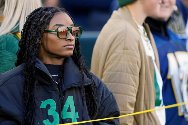 Simone Biles watches the Green Bay Packers and Los Angeles Chargers at Lambeau Field on November 19, 2023 in Green Bay, Wisconsin.
