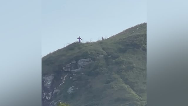 Unidentified figures atop a mountain in Brazil.