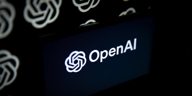 OpenAI logo displayed on a mobile phone screen in front of computer screen on Sept. 5, 2023 in Ankara, Turkey.