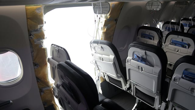 In this National Transportation Safety Board (NTSB) handout, an opening is seen in the fuselage of Alaska Airlines Flight 1282 Boeing 737-9 MAX on January 7, 2024 in Portland, Oregon.