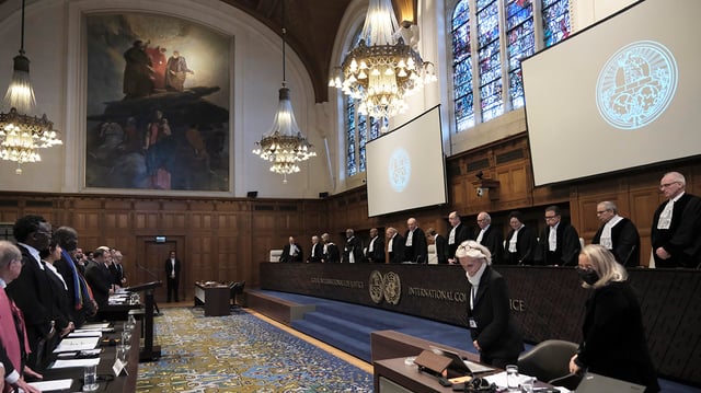 Judges and parties stand at the opening of the hearings at the International Court of Justice in The Hague, Netherlands, Thursday, Jan. 11, 2024. The United Nations’ top court opens hearings Thursday into South Africa’s allegation that Israel’s war with Hamas amounts to genocide against Palestinians, a claim that Israel strongly denies. (AP Photo/Patrick Post)