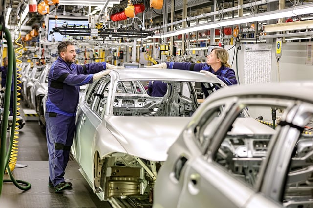 MUNICH, GERMANY - DECEMBER 05: Members of BMW's manufacturing staff inspect a vehicle's finish as they work at the body shop finish during German Chancellor Olaf Scholz visits the BMW Group car factory on December 05, 2023 in Munich, Germany. His visit is taking place as Scholz's government wrestles with a federal budget crisis stemming from a recent Federal Constitutional Court ruling. (Photo by Leonhard Simon/Getty Images)