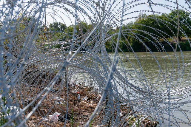 The edge of the Rio Grande in Eagle Pass’ Shelby Park is lined with concertina wire in Eagle Pass, Texas on August 24, 2023. (Photo by SUZANNE CORDEIRO/AFP via Getty Images)
