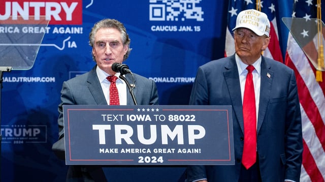 Doug Burgum, governor of North Dakota, center, endorses Donald Trump, during a campaign event at Simpson College in Indianola, Iowa, US, on Sunday, Jan. 14, 2024.