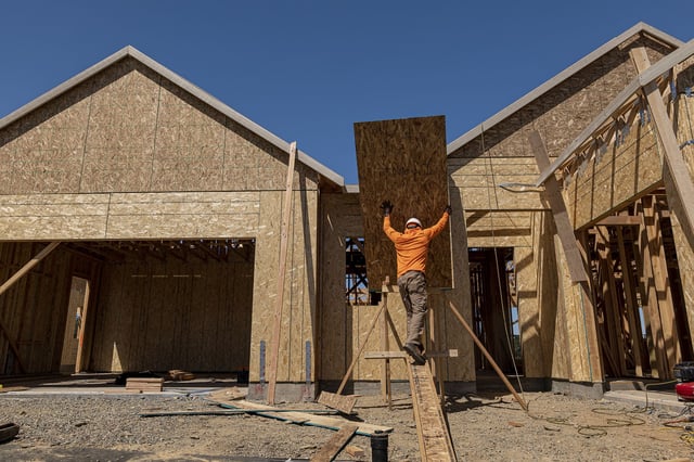 A contractor works on a house under construction at the Toll Brothers Regency at Folsom Ranch community in Folsom, California, US, on Thursday, May 18, 2023.