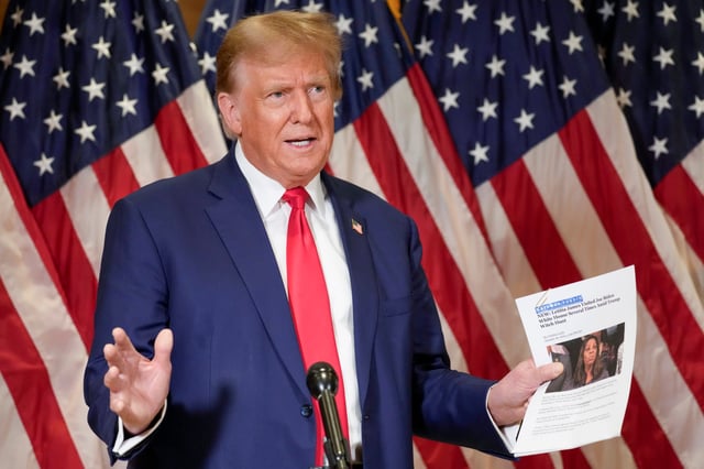 Former President Donald Trump holds up a copy of a story featuring New York Attorney General Letitia James while speaking during a news conference, Thursday, Jan. 11, 2024, in New York. Trump's lawyers presented closing arguments in his civil business fraud trial earlier in the day. (AP Photo/Mary Altaffer)