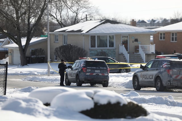 Police work at the scene of a shooting in Tinley Park on Sunday, Jan. 21, 2024. Authorities have identified a woman and her three adult daughters who were found slain inside their suburban Chicago home in what police are calling a domestic-related shooting.