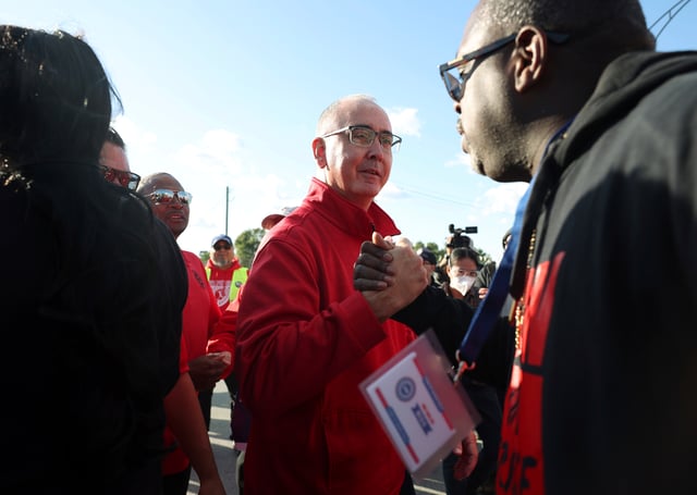 File – United Auto Workers President Shawn Fain, center, visits striking UAW Local 551 workers outside a Ford assembly center on South Burley Avenue on Oct. 7, 2023, in Chicago. Throughout its 5-week-old strikes against Detroit’s automakers, the United Auto Workers union has cast an emphatically combative stance, reflecting the style of Fain, its pugnacious leader. (John J. Kim /Chicago Tribune via AP, File)