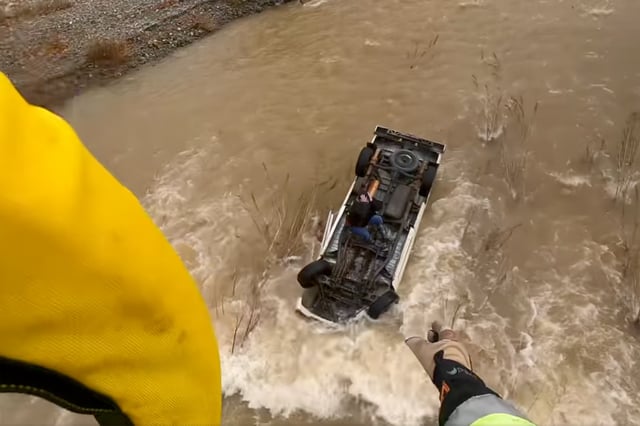 First responders airlifted a woman trapped in a rushing current on top of her overturned car in rural Alameda County, Calif., on Jan. 23, 2024.