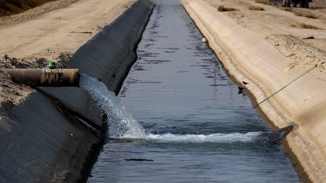 Groundwater is pumped from an aquifer into a canal on the Terranova Ranch in 2021 in Helm, CA.