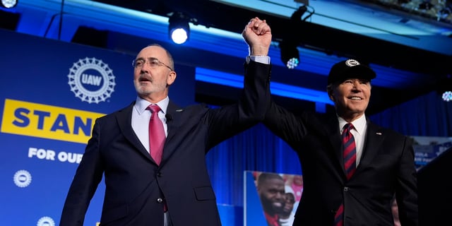 Shawn Fain, president of the United Auto Workers, stands with President Joe Biden at the UAW national convention on Jan. 24, 2024, in Washington, D.C.