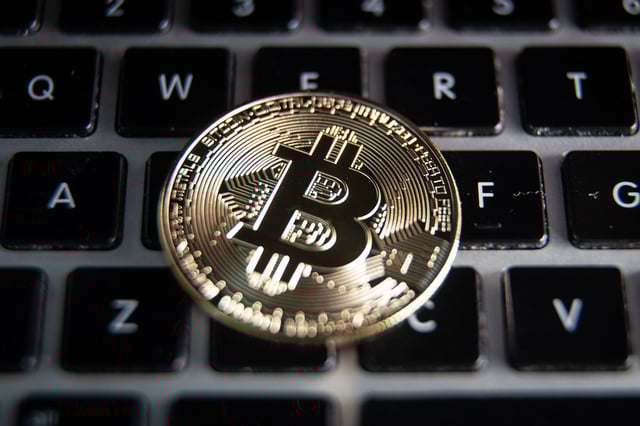 In this photo illustration a novelty Bitcoin token is placed on a computer keyboard, on March 13, 2022 in Bristol, England.